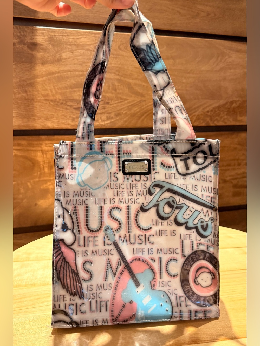 Tous "Life is Music" vinyl tote bag features a playful multi-graphic print
